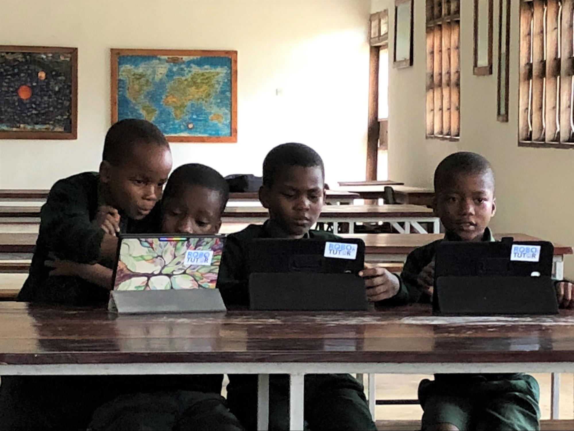 Image of several young children using the roboTutor application